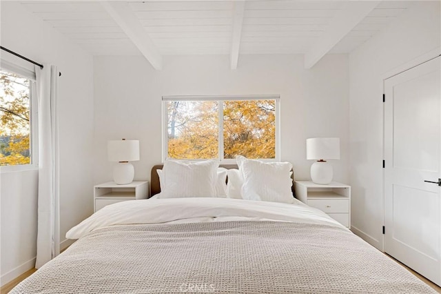 bedroom featuring beamed ceiling and hardwood / wood-style flooring