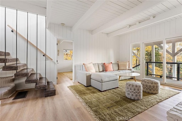 living room featuring beam ceiling and hardwood / wood-style floors