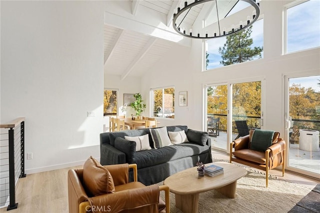 sunroom featuring lofted ceiling with beams