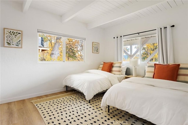 bedroom with wood ceiling, beam ceiling, and light hardwood / wood-style flooring