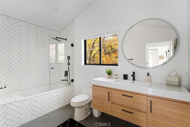 full bathroom featuring tiled shower / bath, vanity, and toilet