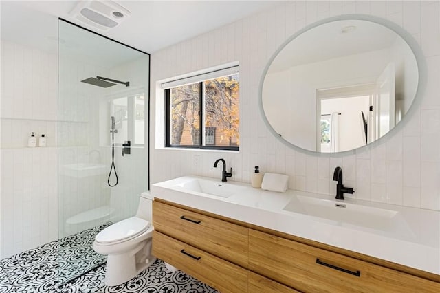 bathroom featuring vanity, backsplash, toilet, and tiled shower