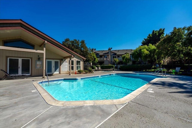 view of pool with a patio and french doors