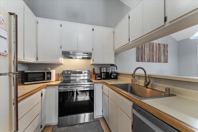 kitchen featuring appliances with stainless steel finishes, sink, and white cabinets