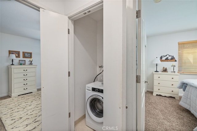 clothes washing area with washer / dryer and light carpet