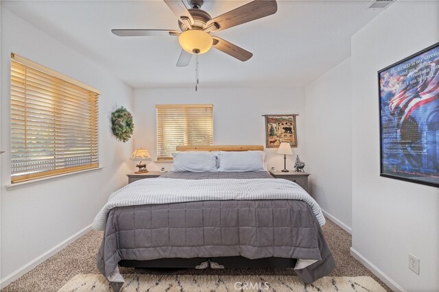 bedroom with ceiling fan and carpet