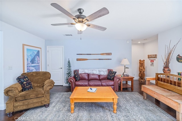 living room with dark hardwood / wood-style floors and ceiling fan