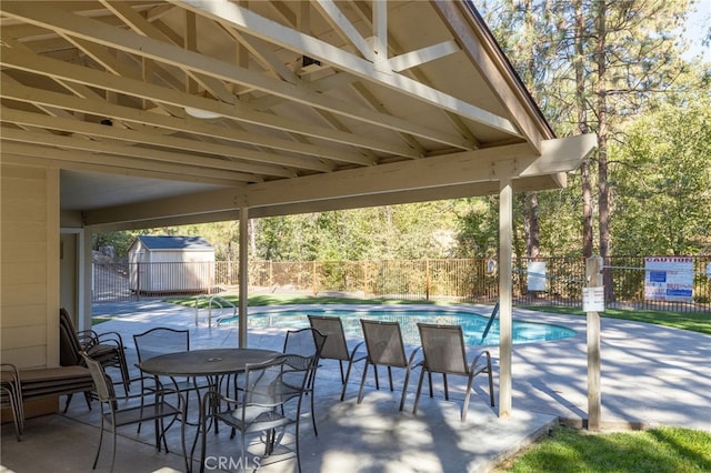 view of patio / terrace with a storage unit and a community pool