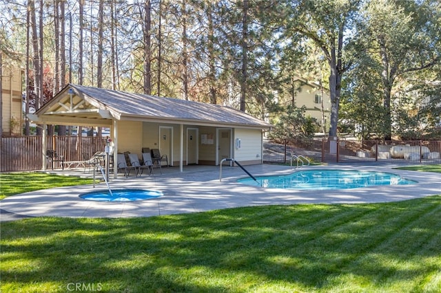 view of swimming pool featuring a patio and a yard