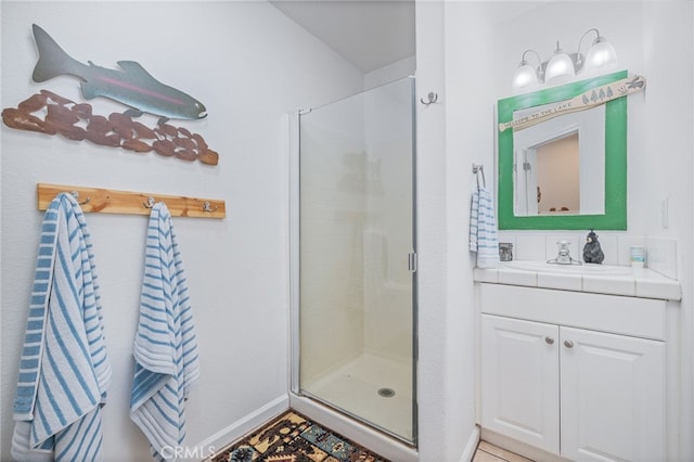 bathroom featuring vanity, walk in shower, and tile patterned floors