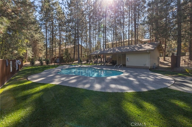 view of pool featuring a patio and a yard