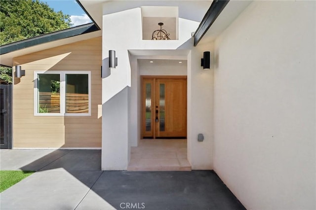 doorway to property featuring a patio area and french doors