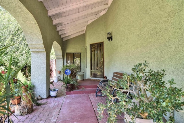 view of exterior entry featuring a patio area