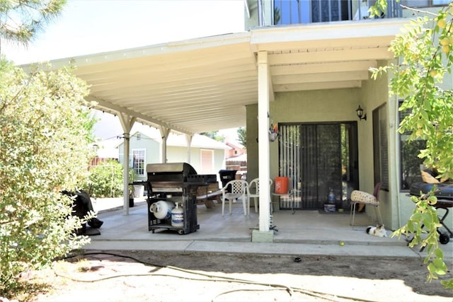 view of patio / terrace featuring a grill and a carport