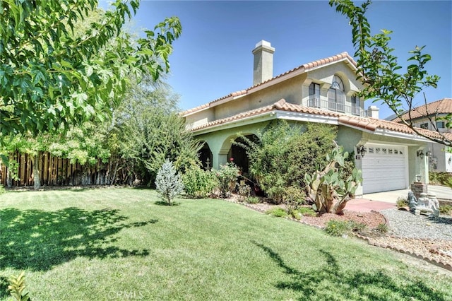 mediterranean / spanish-style house featuring a front yard, a garage, and a balcony