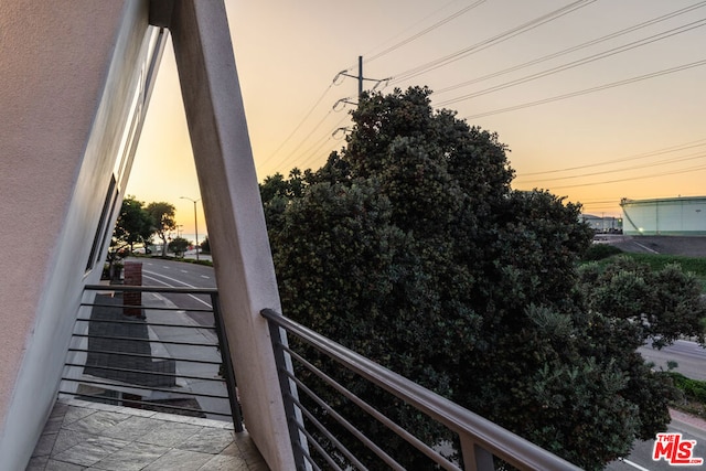 view of balcony at dusk