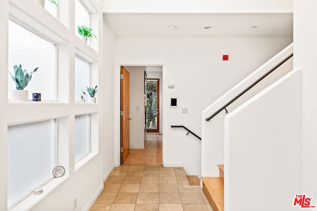 foyer entrance featuring a wealth of natural light and light tile patterned flooring