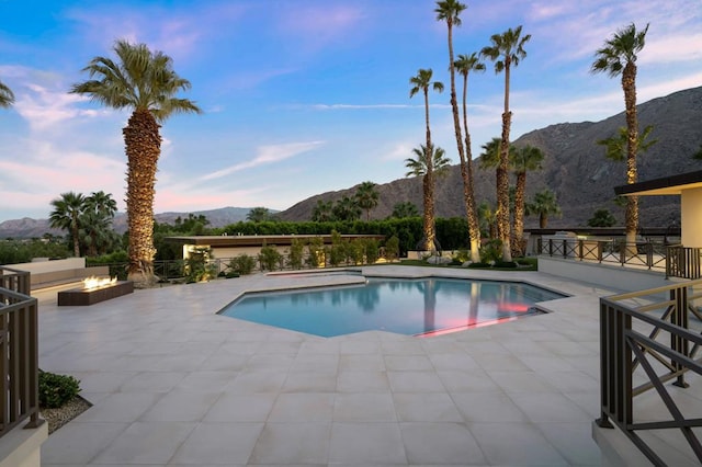 view of pool with a mountain view and a patio area