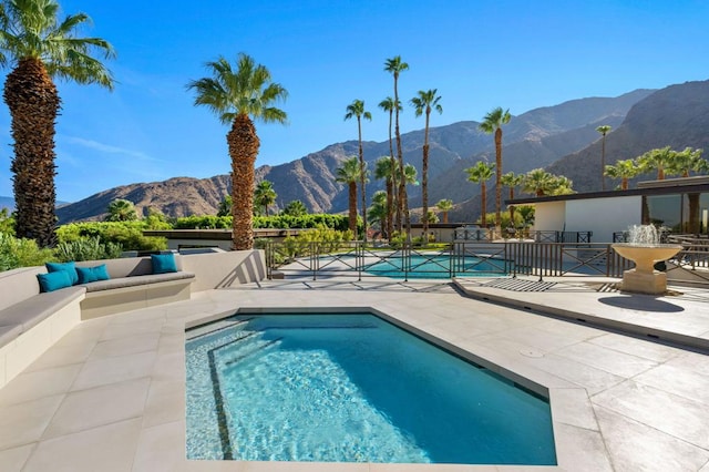 view of pool with a mountain view and a patio area