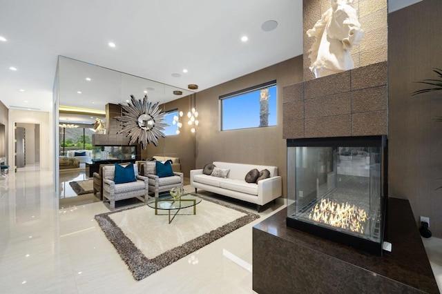 living room featuring tile patterned flooring, plenty of natural light, and a fireplace