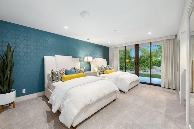 carpeted bedroom featuring french doors, access to exterior, and floor to ceiling windows