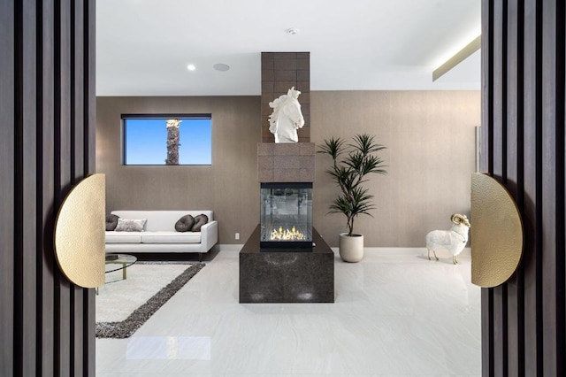 living room featuring a tiled fireplace