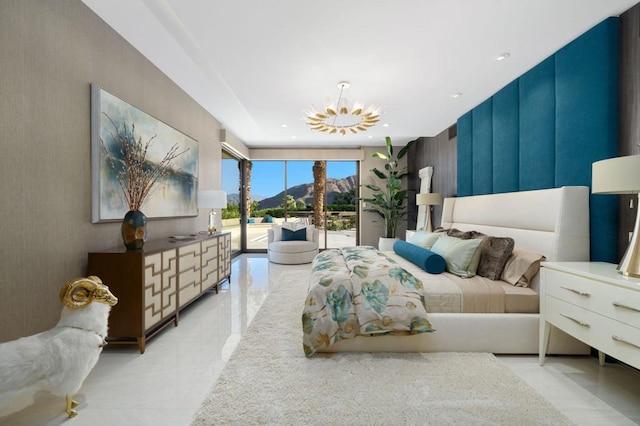 bedroom with access to outside, an inviting chandelier, and expansive windows