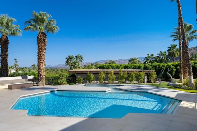 view of pool featuring a patio and a mountain view