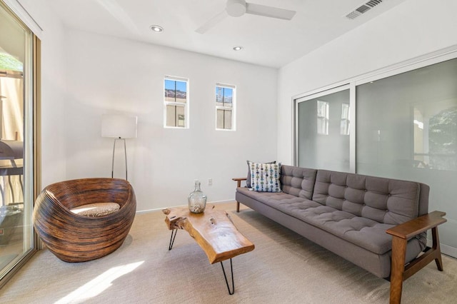 carpeted living room featuring ceiling fan