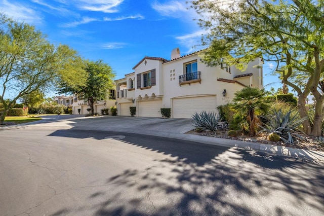 mediterranean / spanish-style home with a garage