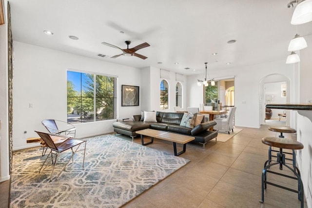 tiled living room with ceiling fan