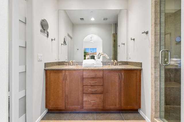 bathroom with tile patterned flooring, vanity, a shower with door, and ceiling fan