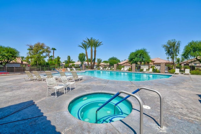 view of pool featuring a patio and a hot tub