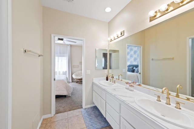 bathroom with tile patterned flooring, vanity, and ceiling fan