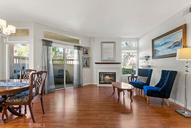 living area featuring a notable chandelier and hardwood / wood-style flooring