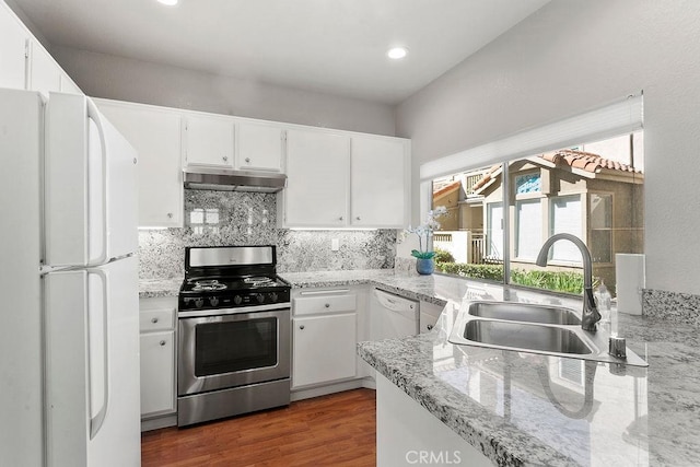 kitchen with sink, dark wood-type flooring, light stone counters, white appliances, and white cabinets