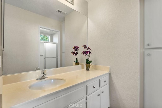 bathroom featuring vanity and walk in shower