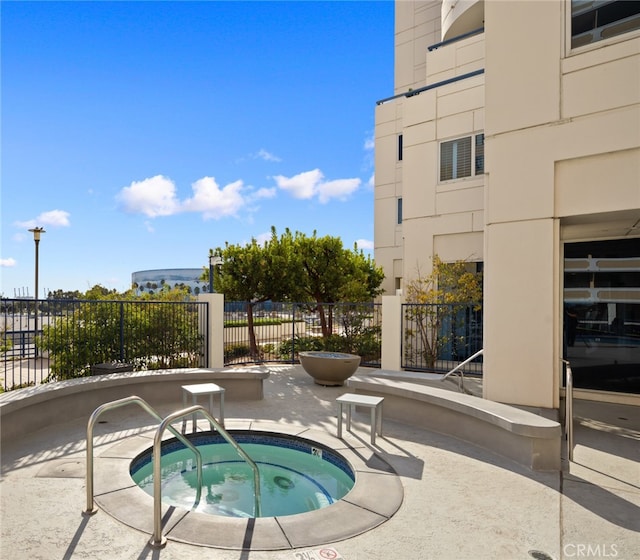 view of swimming pool with a patio and a community hot tub