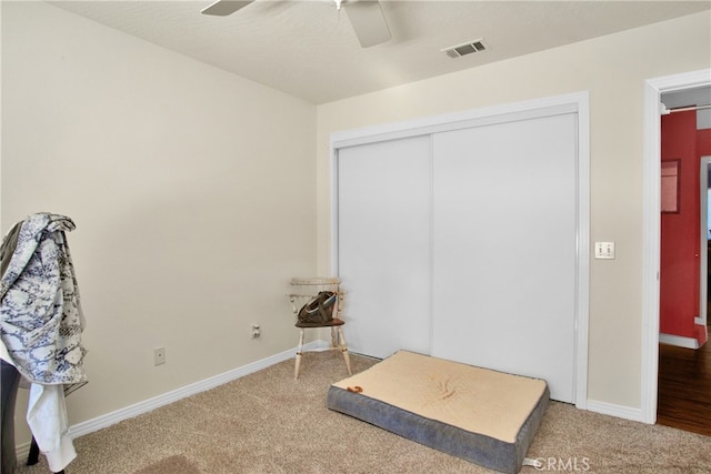 carpeted bedroom with a closet and ceiling fan