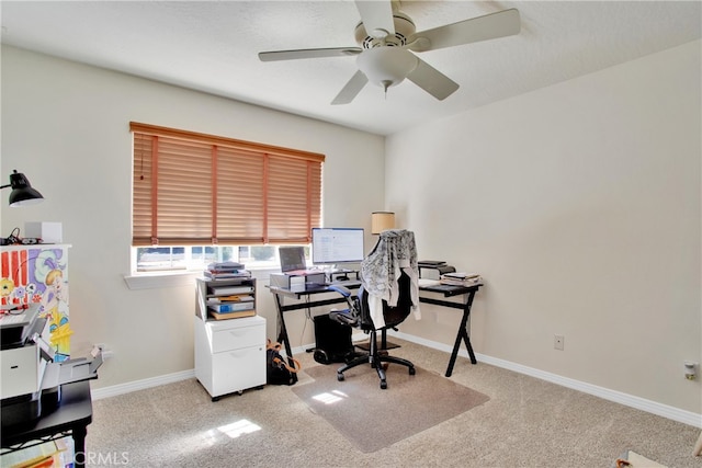 carpeted office featuring ceiling fan