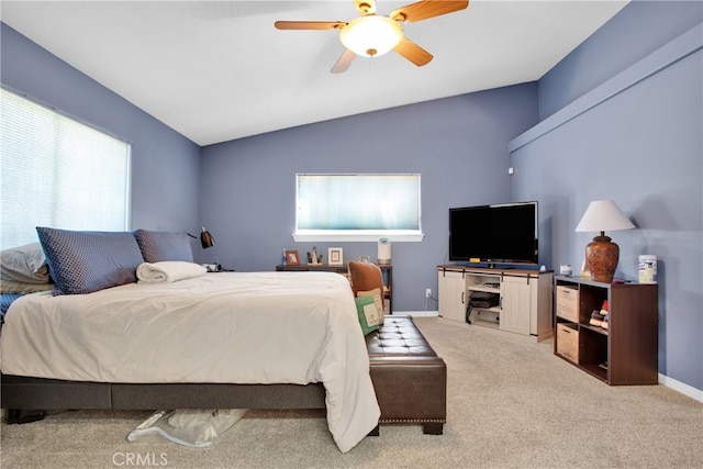 bedroom featuring vaulted ceiling, light colored carpet, and ceiling fan