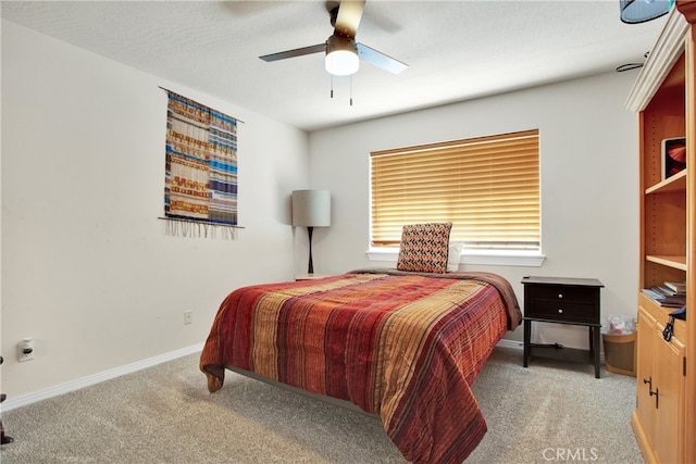 carpeted bedroom featuring a textured ceiling and ceiling fan