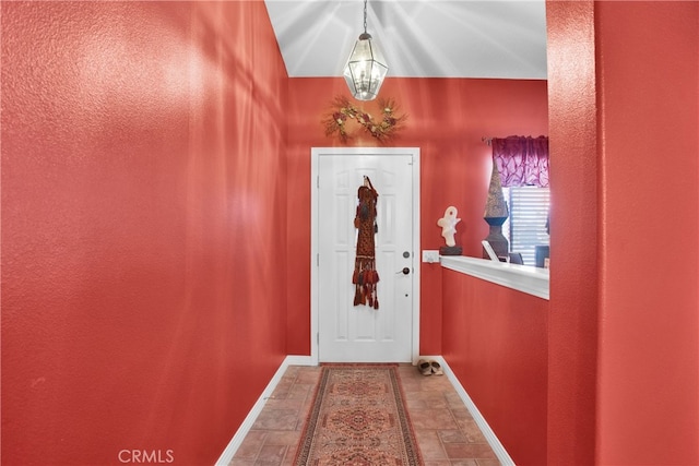 entryway with a chandelier