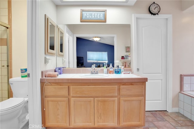 bathroom with vanity, lofted ceiling, toilet, and walk in shower