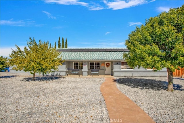 19848 Haida Rd, Apple Valley, CA 92307 - view of front facade with roof mounted solar panels, a tile roof, a porch, and stucco siding