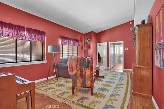 sitting room featuring vaulted ceiling and light hardwood / wood-style flooring