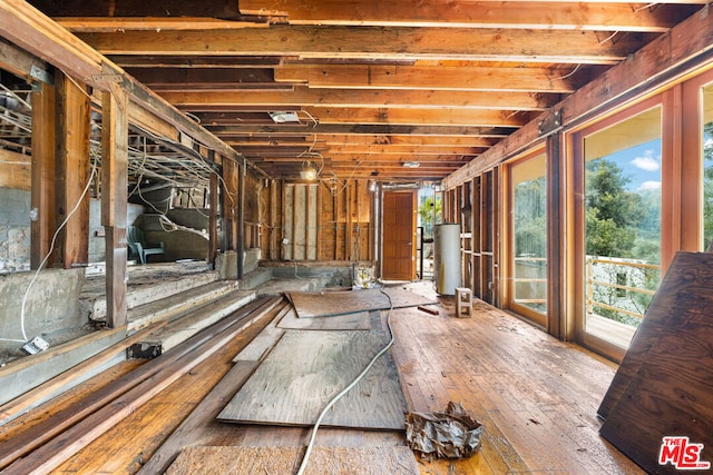 miscellaneous room with gas water heater and hardwood / wood-style flooring