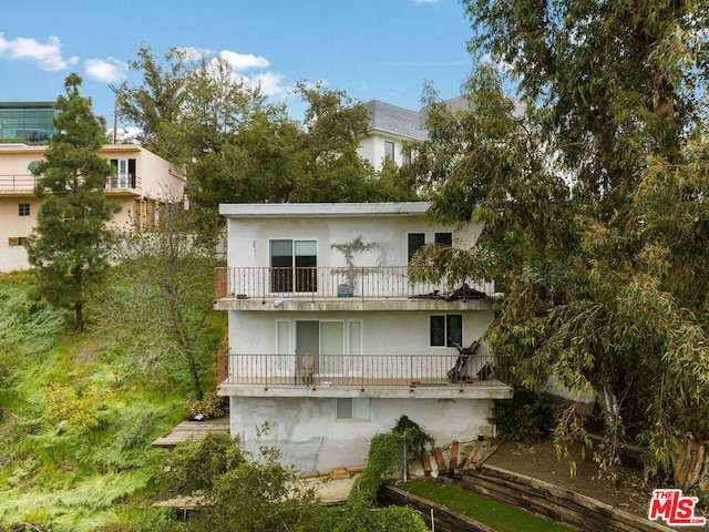 rear view of property with a balcony