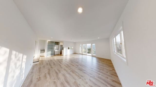 unfurnished living room featuring light wood-type flooring