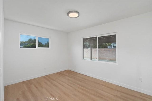 unfurnished room with light hardwood / wood-style flooring